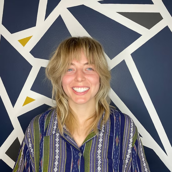 Blonde layered haircut with curtain bangs Albuquerque hair salon